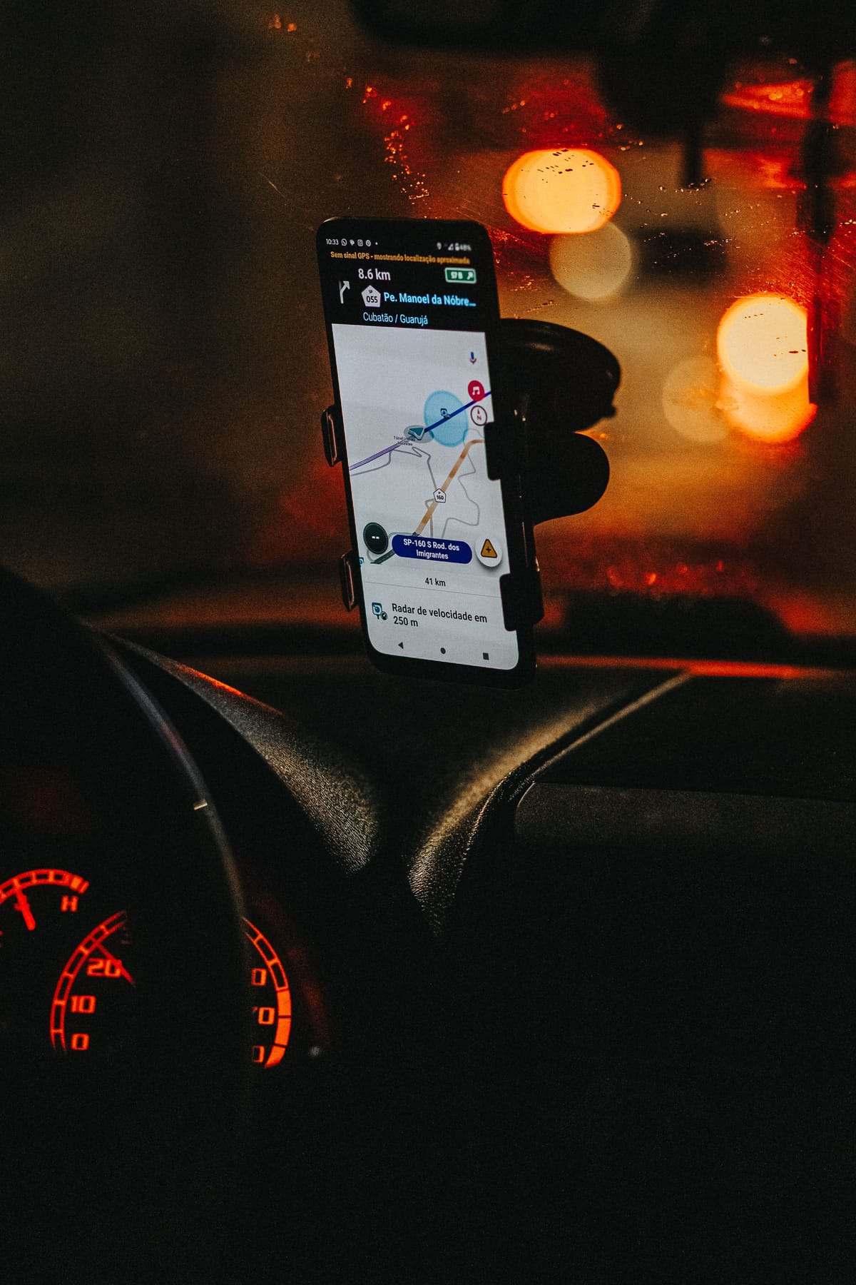 A phone on a car dashboard at night