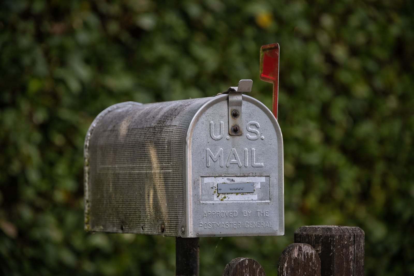 A classic U.S. Mail roadside mailbox with its red flag up